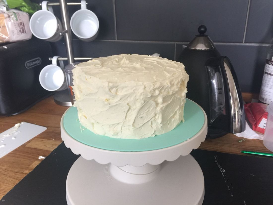 Buttercream-frosted layer cake on a cake stand